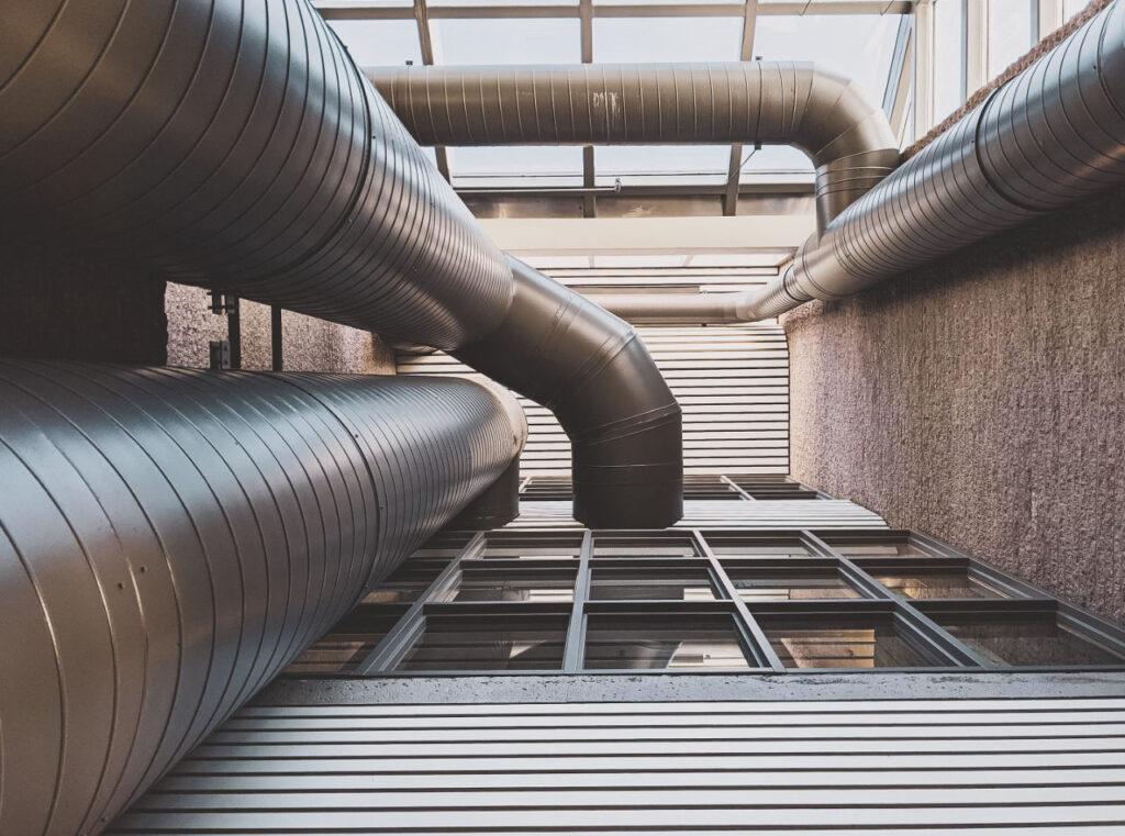 Industrial HVAC pipes running throughout a facility