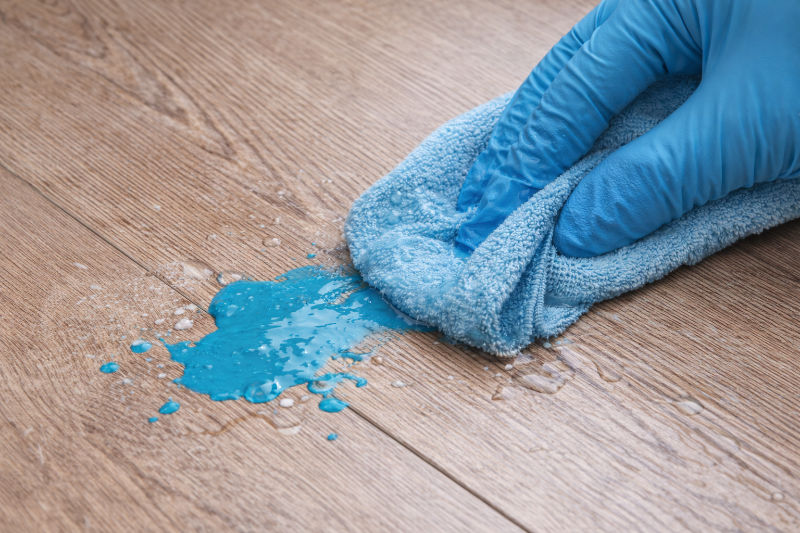 Gently wiping blue paint off of laminate floor
